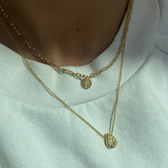 Canary diamond necklace, yellow pear shape diamond on a golden chain, bezel set yellow diamond