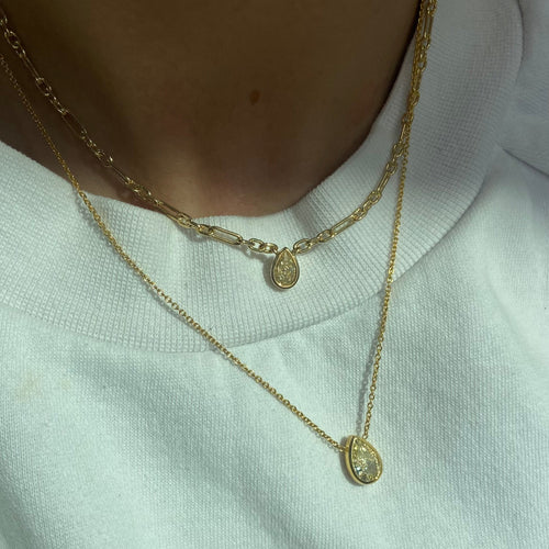Canary diamond necklace, yellow pear shape diamond on a golden chain, bezel set yellow diamond