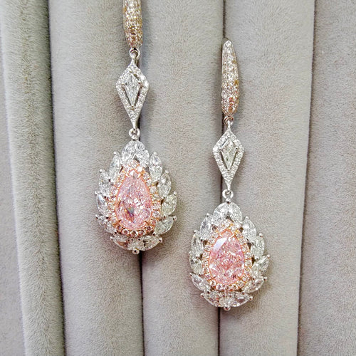 pink diamond earrings. pink diamonds. pink diamond jewelry. pink diamond studs. pink diamond drop earrings. pink and white diamond earrings. pink diamond pear shaoes.