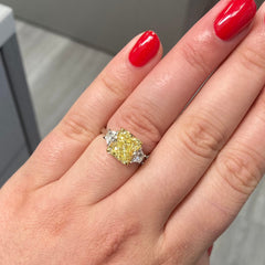 4 carat fancy yellow radiant set in 3 stone platinum ring