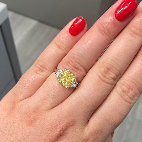 4 carat fancy yellow radiant set in 3 stone platinum ring