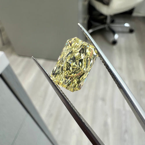 Fancy yellow elongated radiant diamond with VVS2 clarity and excellent cut.