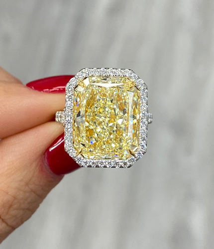 Luxurious yellow diamond ring with white halo diamonds and a SI1 clarity.