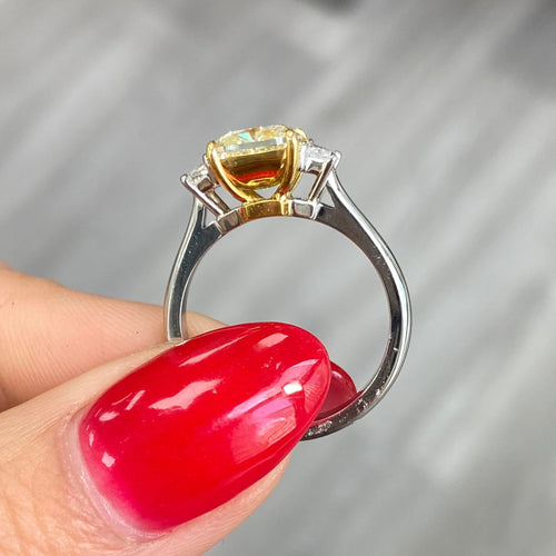 2.28 Carat Center Fancy Light Yellow Cushion Cut Diamond SI2 Clarity 0.32 Carats of E Color Trapezoids GIA Certified Diamond Crafted in Platinum and 18k Yellow Gold Handmade in NYC
