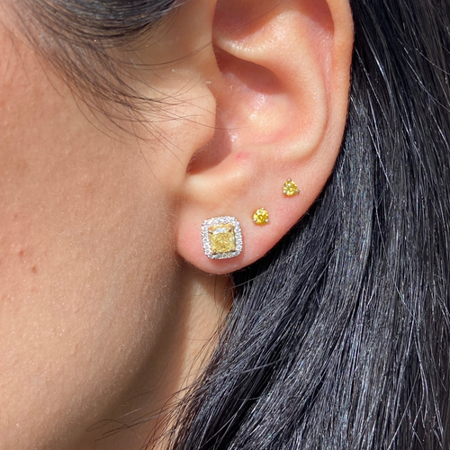 Fancy intense yellow cushion diamond studs with a F/VS2 clarity.