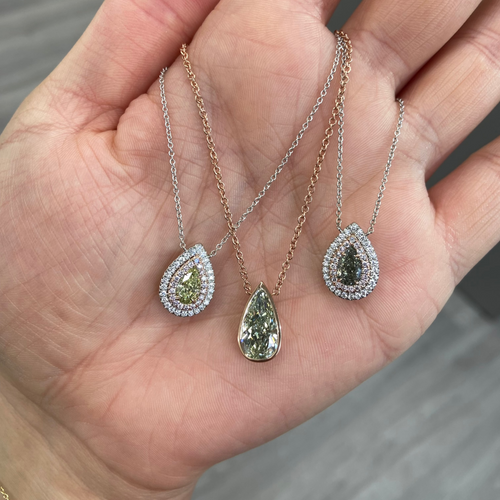 Elegant greenish yellow pear-shaped diamond pendant with a double halo design and unique charm with a SI2 clarity.