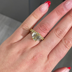 Light yellow emerald-cut diamond ring with excellent cut, VS2 clarity, and GIA certification.
