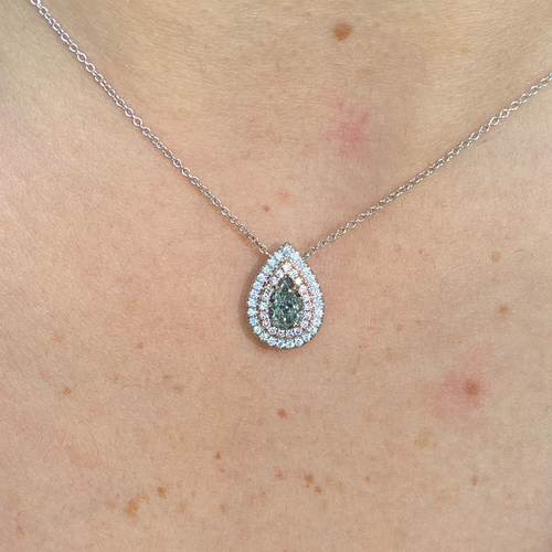 Unique green chameleon pear-shaped diamond pendant with double halo and VS1 clarity center diamond.