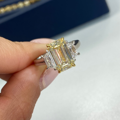 Light yellow emerald-cut diamond ring with excellent cut, VS2 clarity, and GIA certification.