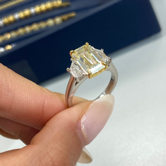 Light yellow emerald-cut diamond ring with excellent cut, VS2 clarity, and GIA certification.