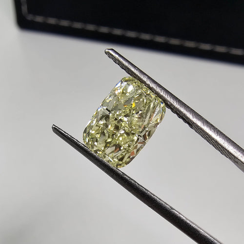 GIA certified light yellow elongated cushion cut diamond with VVS1 clarity.