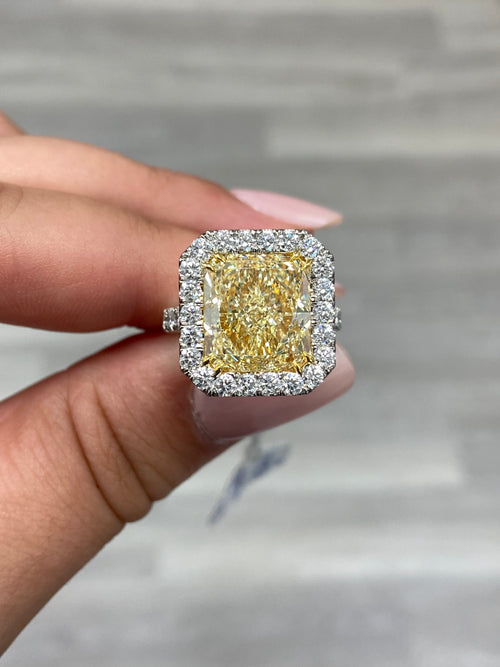 Elegant light yellow diamond engagement ring featuring a radiant cut with VS1 clarity.