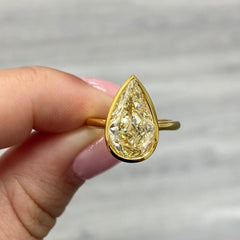Bezel set diamond ring. Bezel engagement ring. 5 carat ring. Pear shape diamond ring.