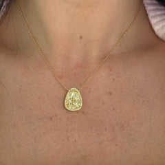 Old money light yellow pear-shaped diamond pendant, accented by a radiant halo of yellow diamonds with SI1 clarity.