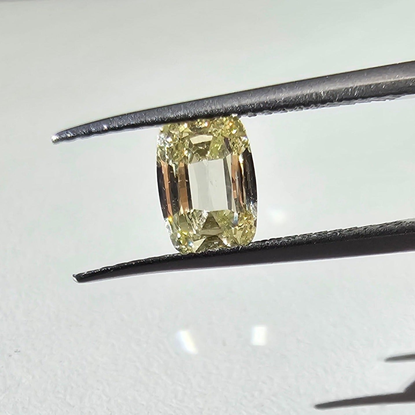 Unique yellow pear-shaped diamond pendant necklace with a radiant halo.