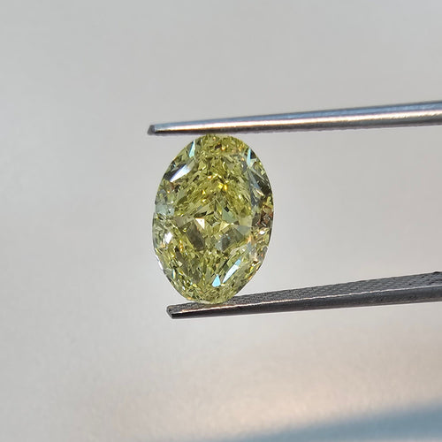 Fancy yellow oval cut diamond with excellent clarity and precision, GIA certified.