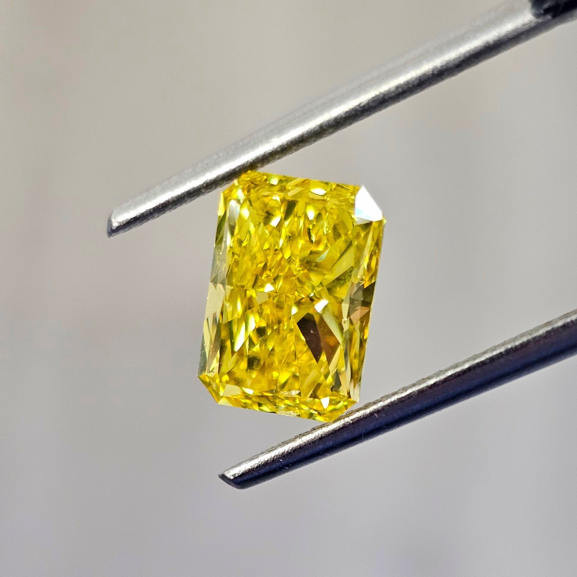 Fancy vivid yellow natural diamond, elongated radiant cut diamond