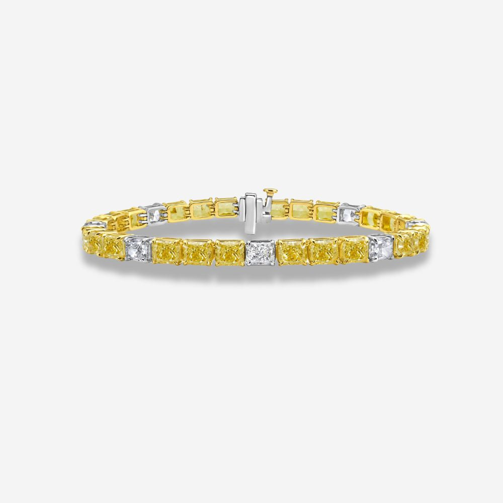 Yellow and white diamond bracelet on a light gray background