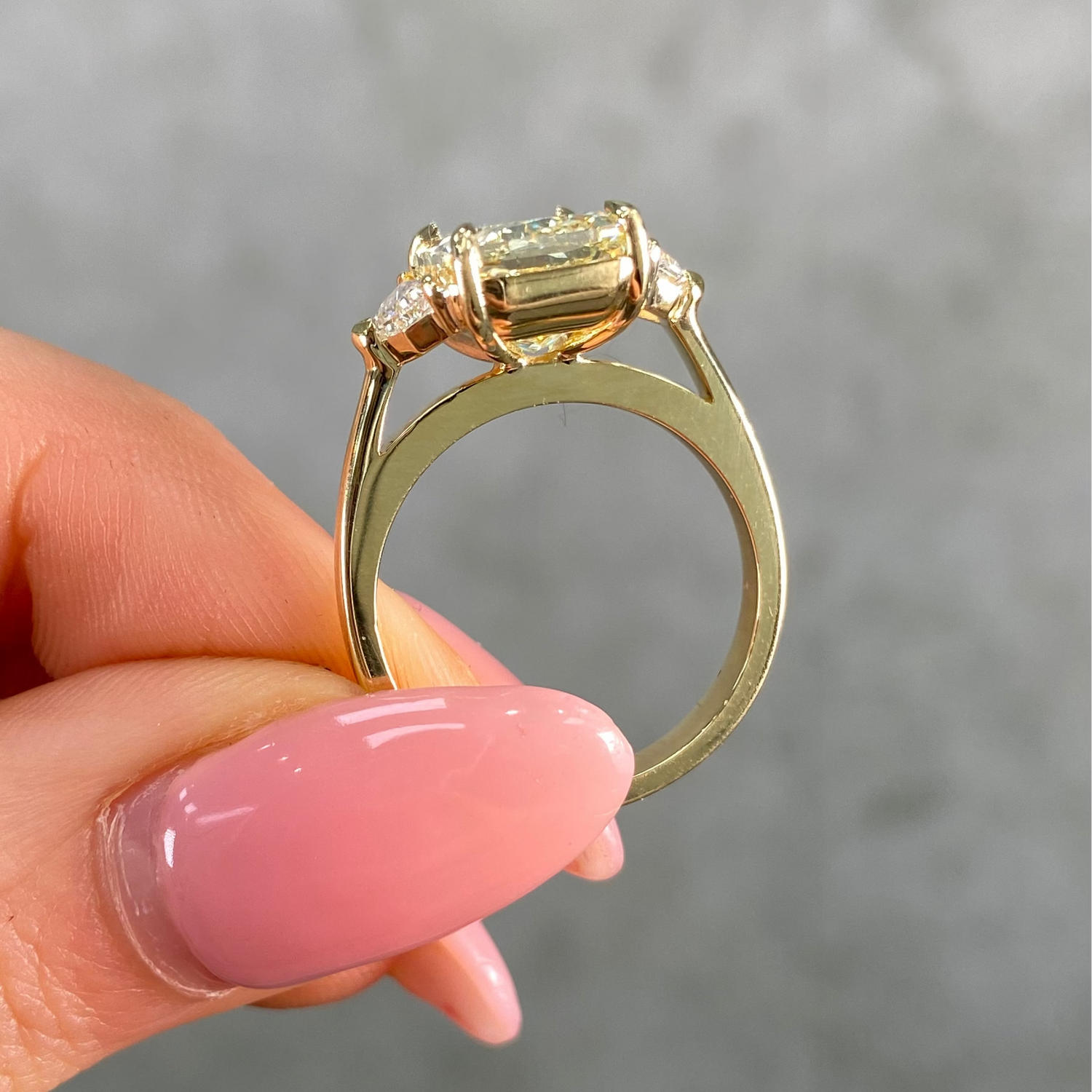 5 carat fancy light yellow elongated radiant cut diamond ring in yellow gold side profile