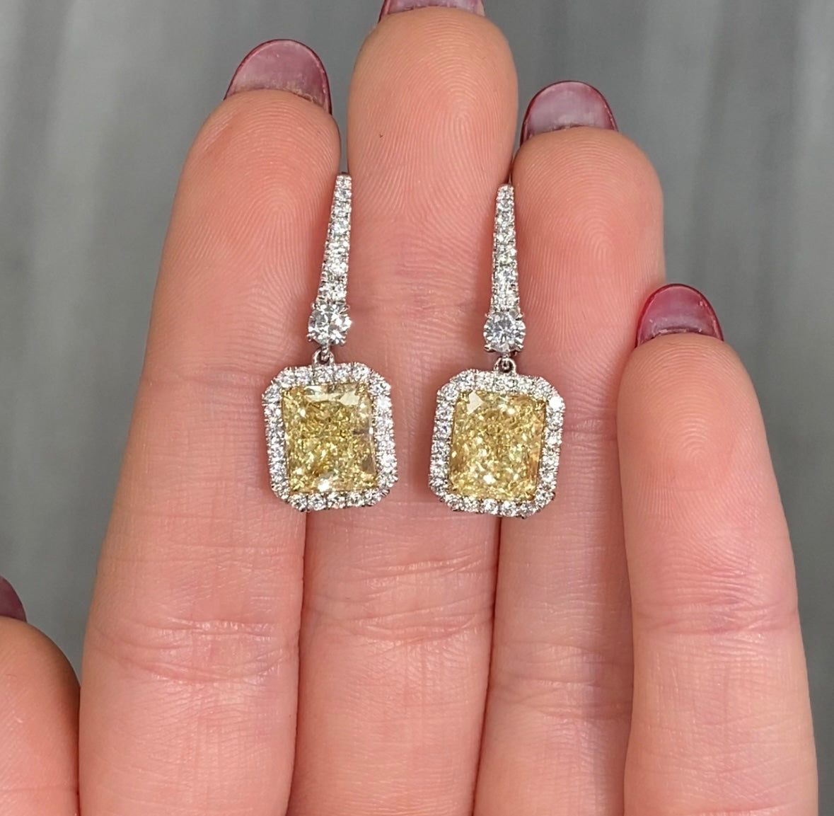 6ct Fancy Light Yellow Radiant Drop Earrings in a white diamond halo