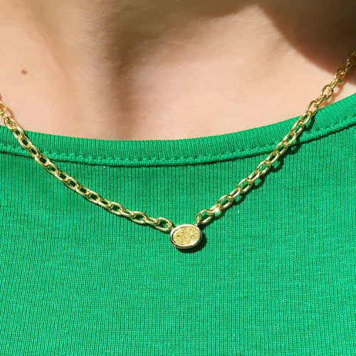 Canary diamond necklace, yellow pear shape diamond on a golden chain, bezel set yellow diamondCanary diamond necklace, yellow oval cut diamond on a golden chain, bezel set yellow diamond