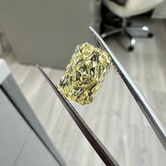 Fancy yellow elongated radiant diamond with VVS2 clarity and excellent cut.