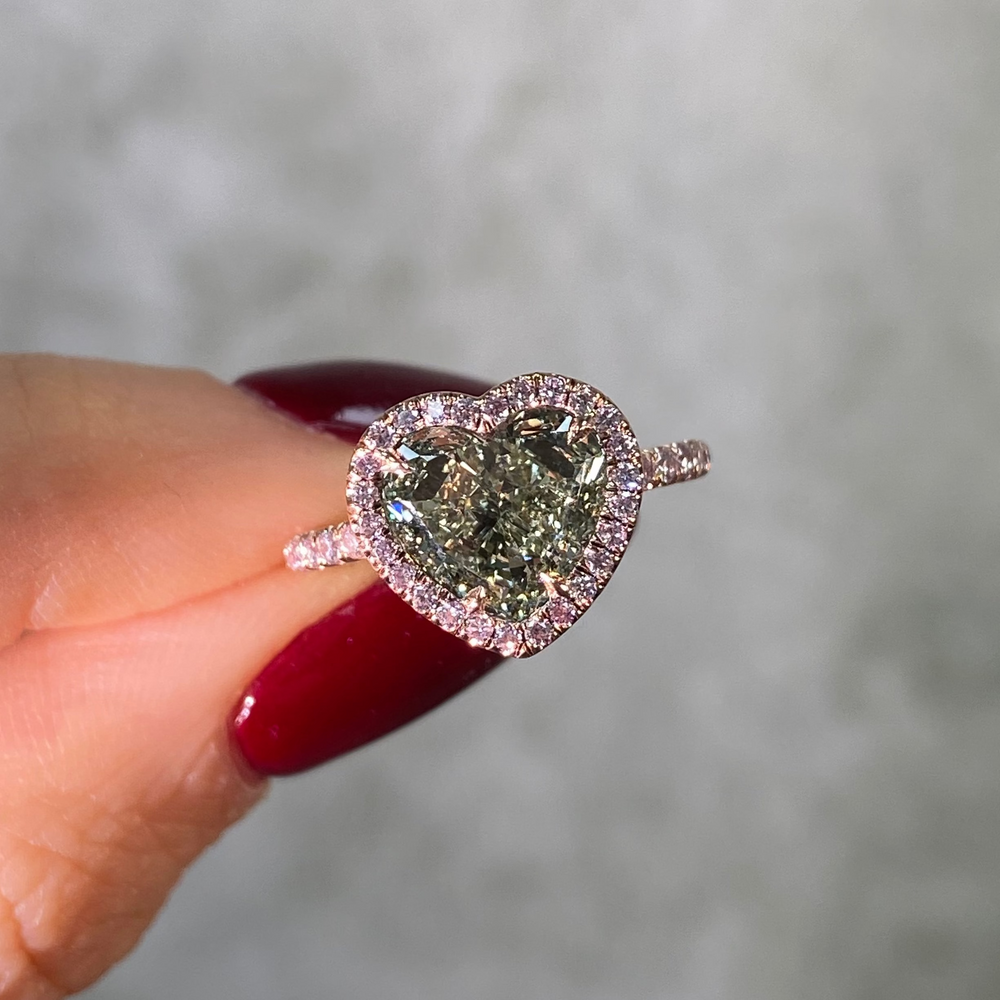Green diamond heart shape ring with pink diamonds photo on hand 