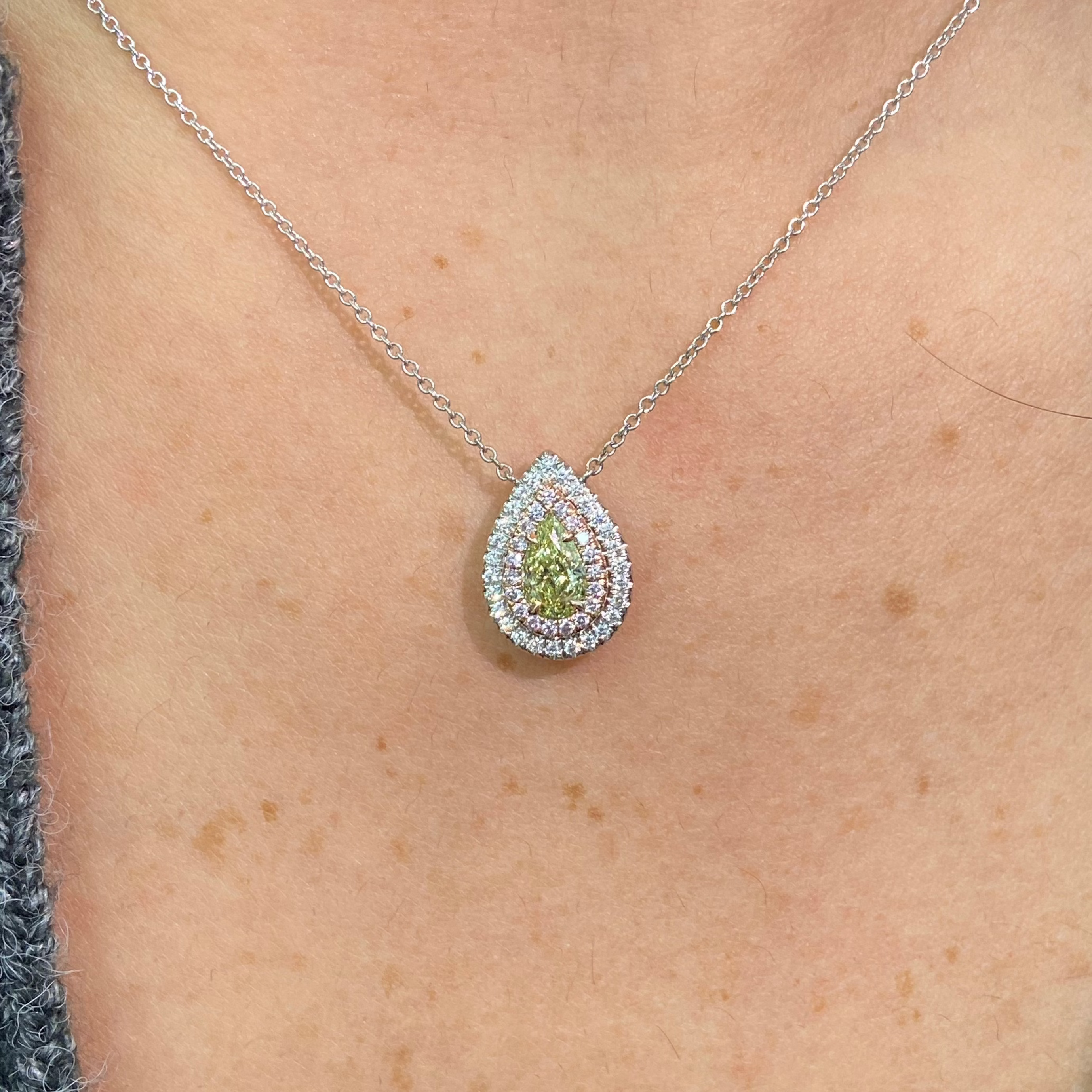 Elegant greenish yellow pear-shaped diamond pendant with a double halo design and unique charm with a SI2 clarity.