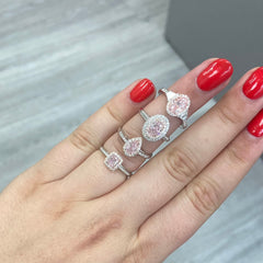 Pink diamond ring. pink diamond engagement ring. light pink diamonds. light pink cushions. diamond ring.