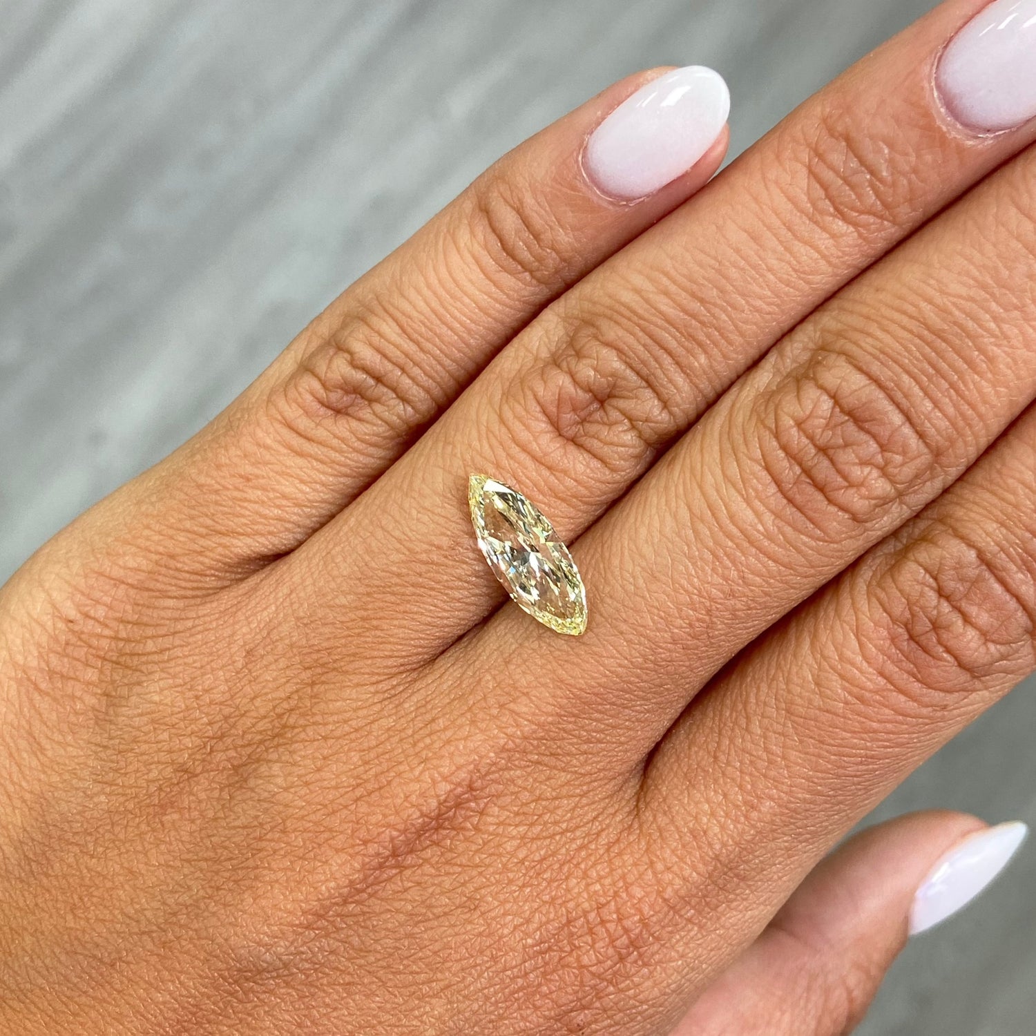 Fancy Yellow marquise cut diamond with VS1 clarity and no fluorescence.