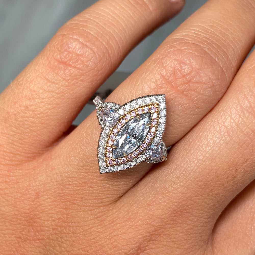 Fancy blue elongated diamond ring. blue marquis diamond. light blue diamond.