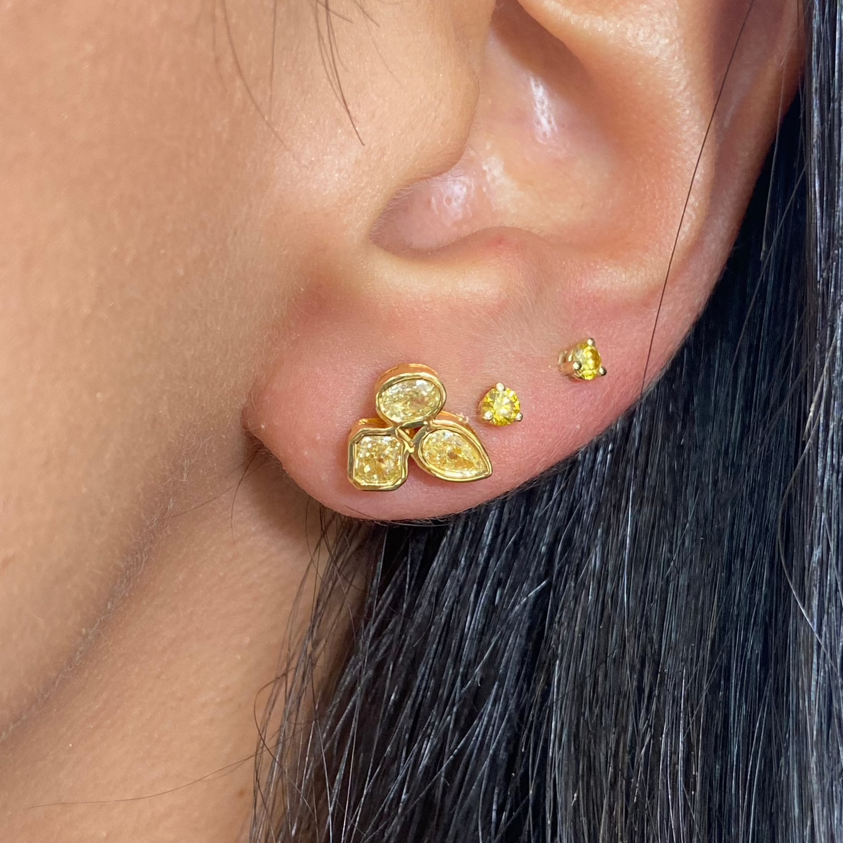 Celebrity style unique earrings with pear, radiant, and oval cut diamonds.