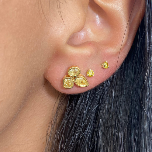 Celebrity style unique earrings with pear, radiant, and oval cut diamonds.