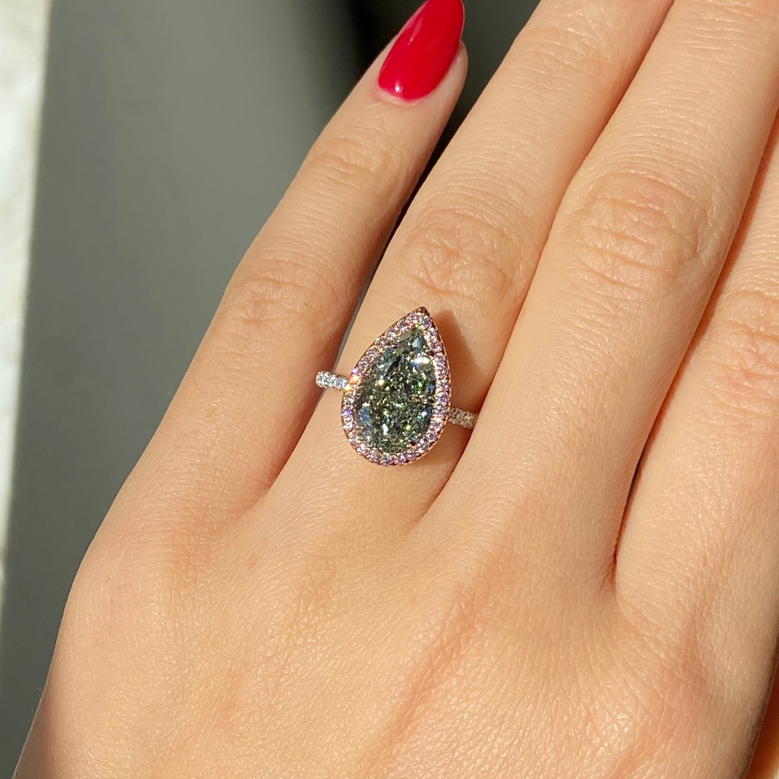 GIA certified fancy pear shaped green ring with pink diamonds. 