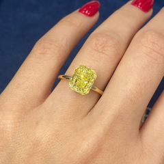 Unique GIA certified fancy vivid yellow elongated radiant cut diamond with flawless clarity.