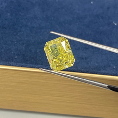 Unique GIA certified fancy vivid yellow elongated radiant cut diamond with flawless clarity.