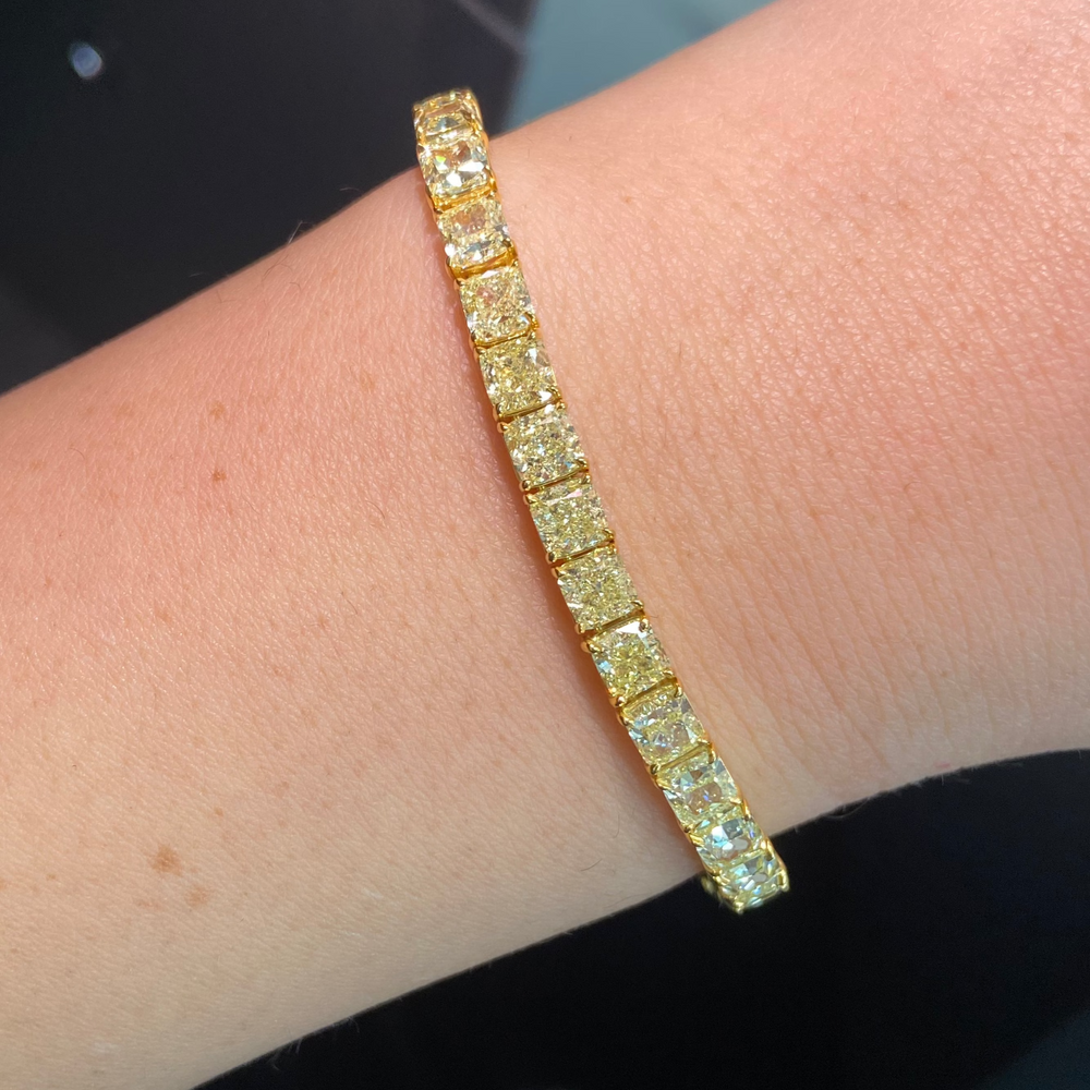 Fancy yellow diamond bracelet. Cushion diamond bracelet. Cushion tennis bracelet. Yellow diamond jewelry. Yellow tennis bracelet. Natural yellow diamonds.