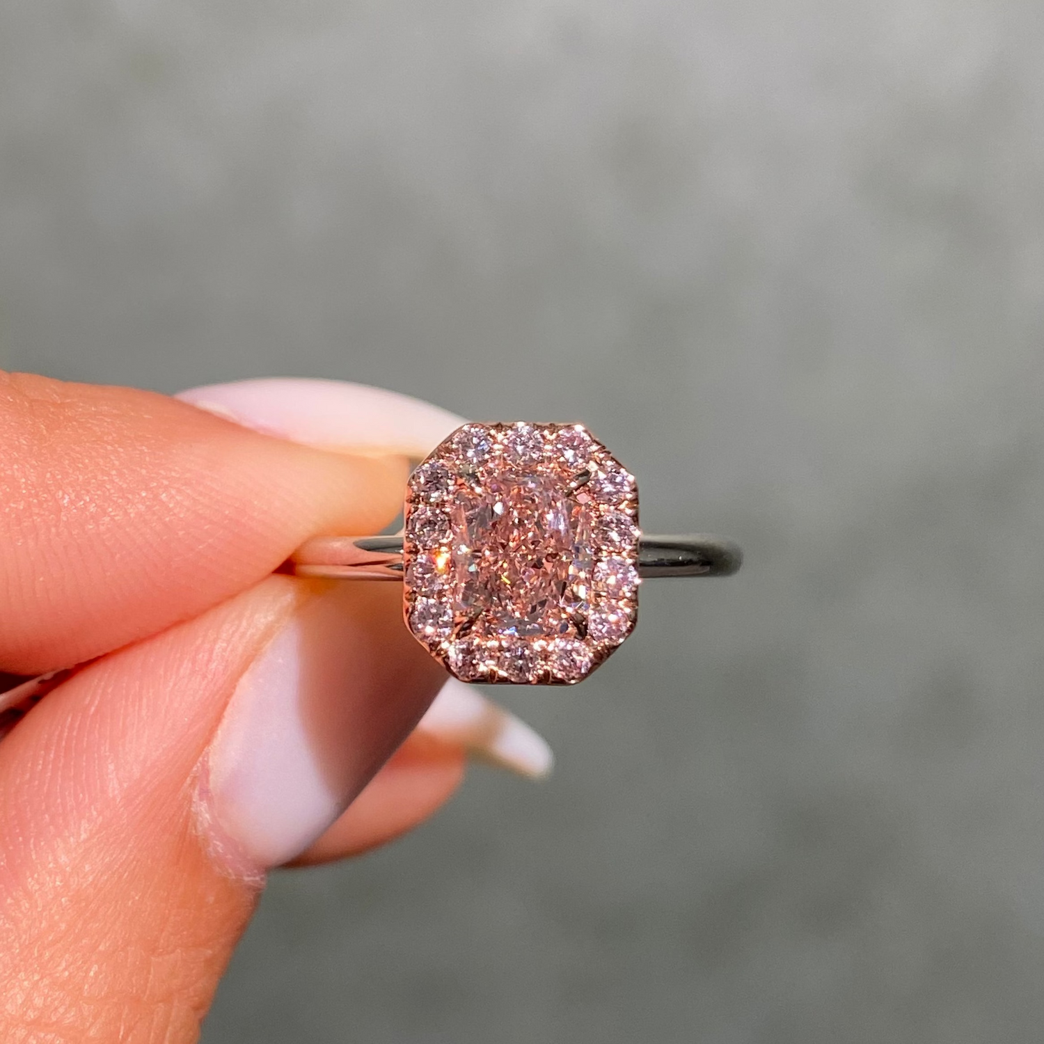 1ct GIA fancy brownish pink elongated radiant diamond halo engagement ring with pink rounds - close-up detail | Rare Colors by Namdar, NYC