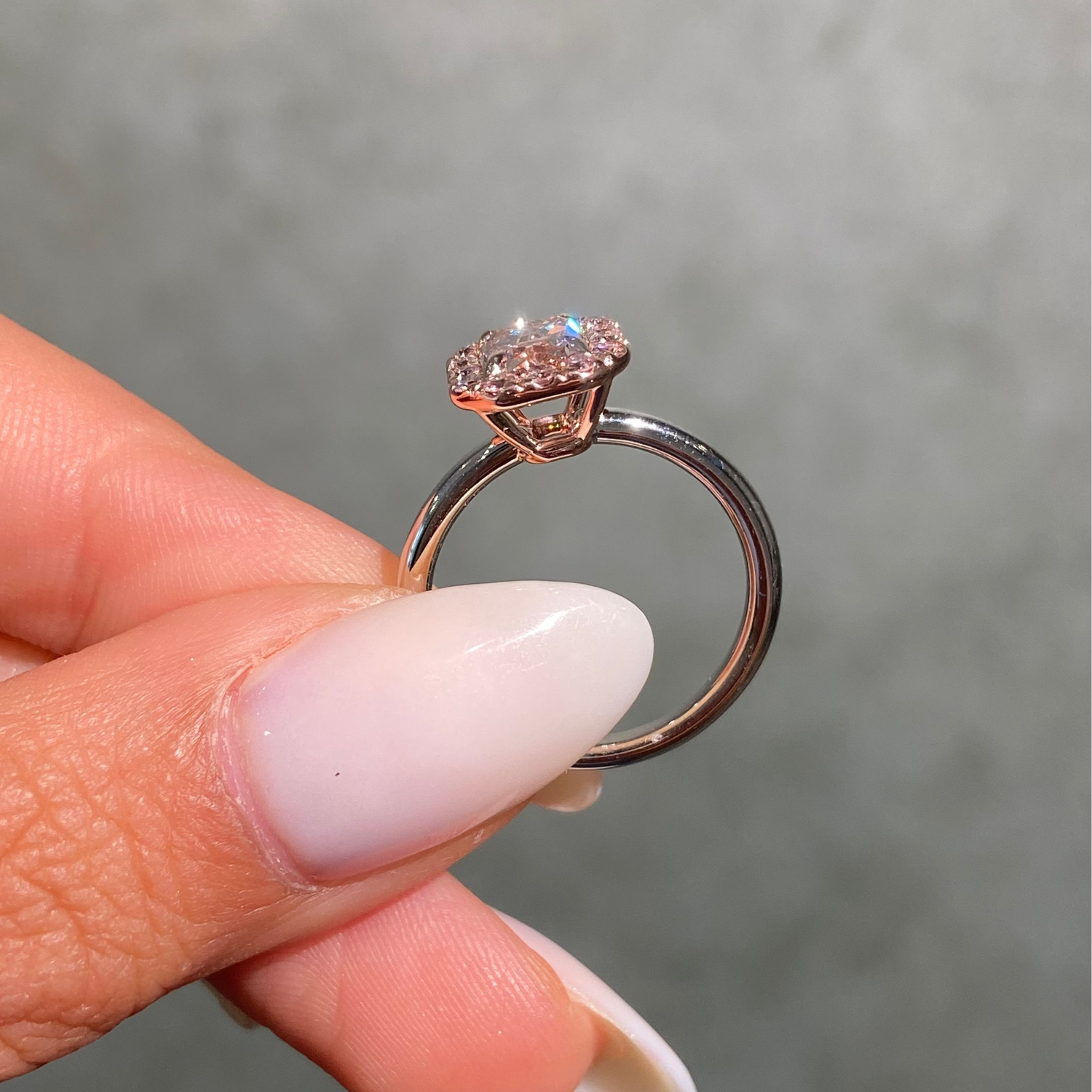 1ct GIA fancy brownish pink elongated radiant diamond halo engagement ring with pink rounds - side profile | Rare Colors by Namdar, NYC