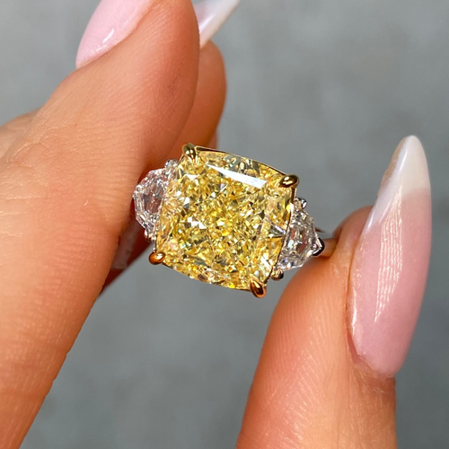 7 carat Yellow diamond ring on a finger with a neutral background