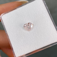 Heart-shaped light pink diamond held by female 