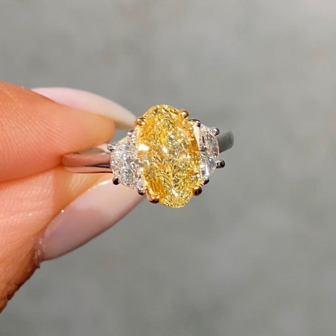 2.02ct GIA light yellow oval diamond three stone engagement ring with half moon sides - close-up detail | Rare Colors by Namdar, NYC