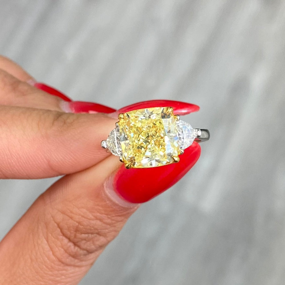 Fancy yellow elongated cushion diamond elongated diamond canary diamond three stone engagement ring, GIA certified.