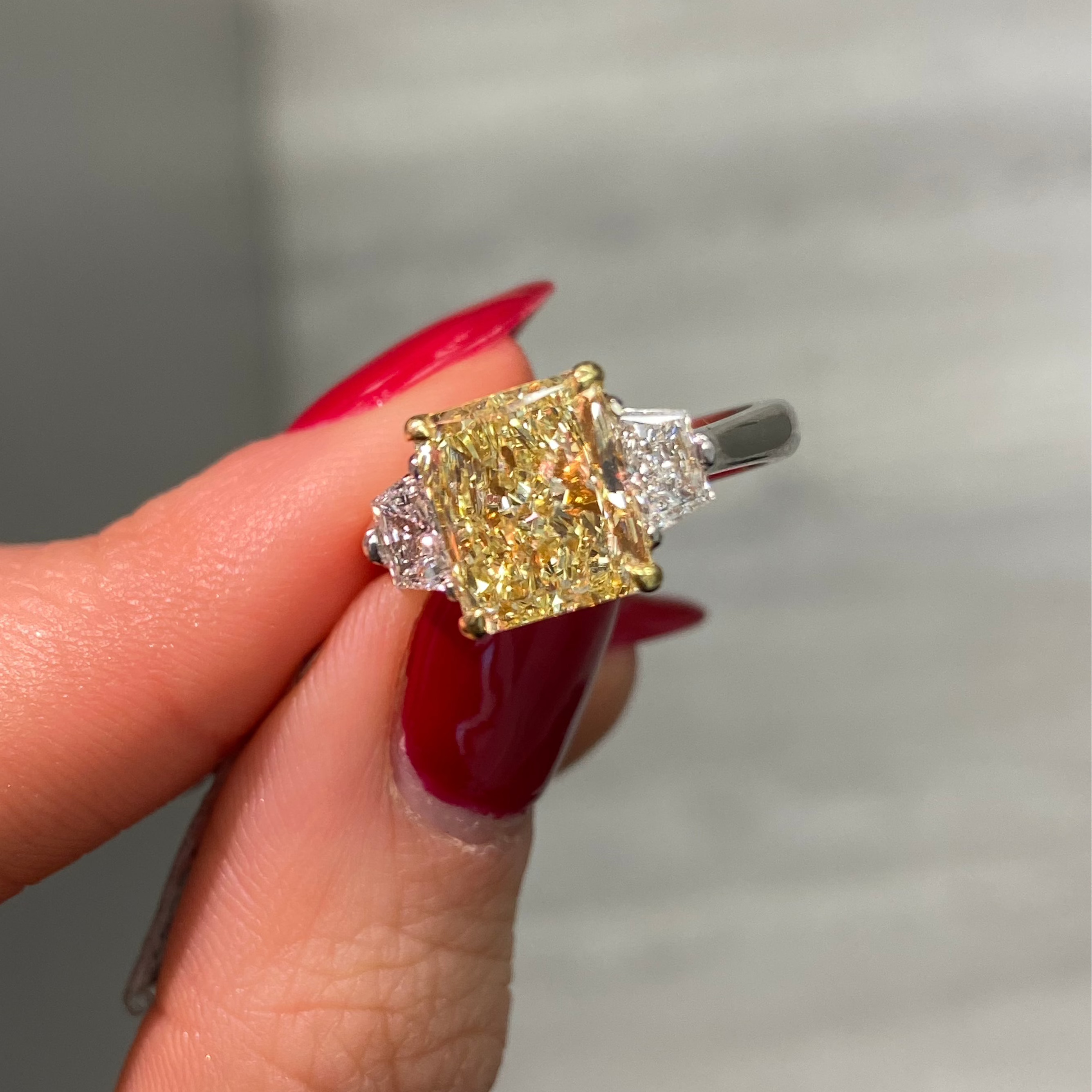 Fancy yellow engagement ring, three stone diamond ring, yellow diamond ring, yellow radiant diamond.