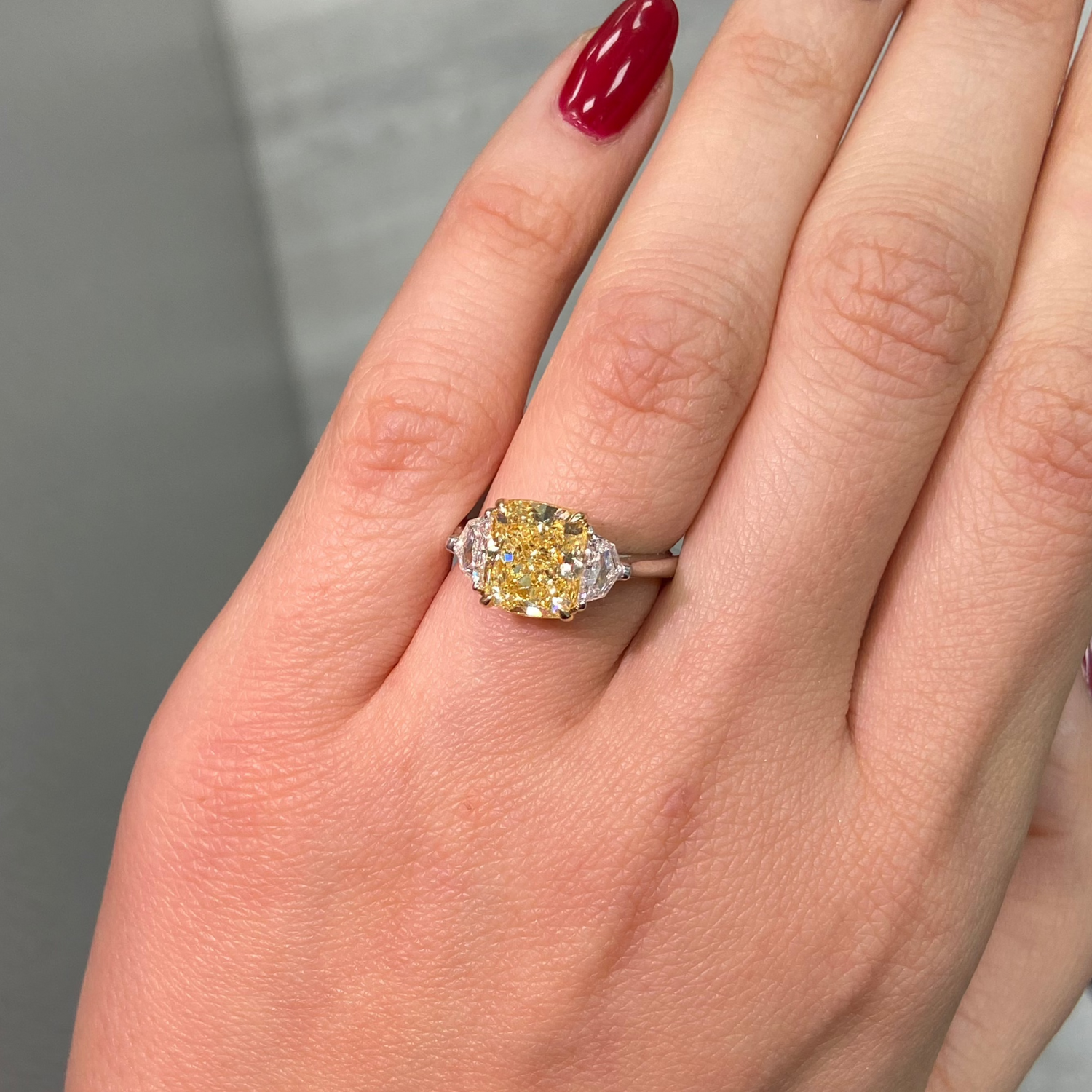 3 Carat Fancy Yellow VVS1 Cushion Diamond 3 Stone Ring, unique engagement ring style.