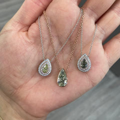 Elegant greenish yellow pear-shaped diamond pendant with a double halo design and unique charm with a SI2 clarity.