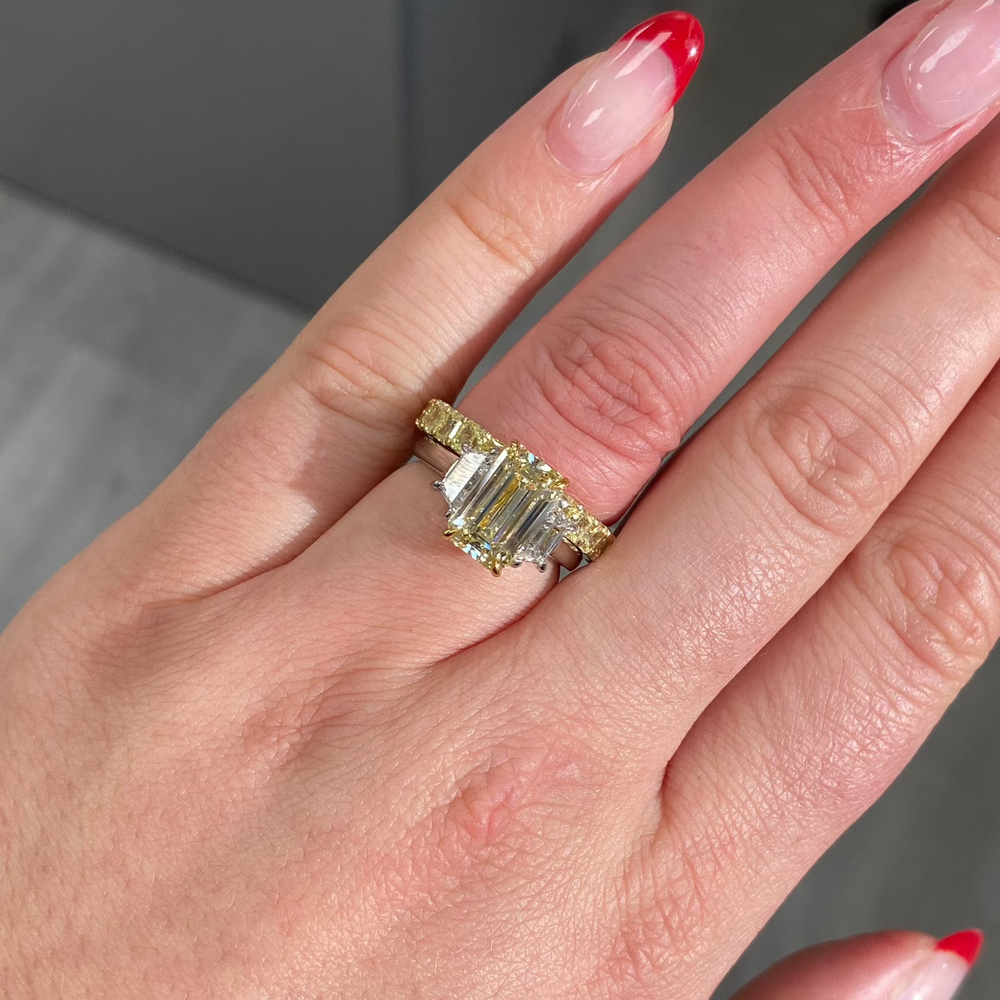Light yellow emerald-cut diamond ring with excellent cut, VS2 clarity, and GIA certification.