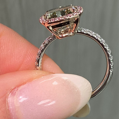 GIA certified greenish yellow cushion diamond in a pink halo engagement ring with VS1 clarity.