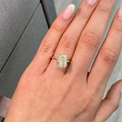 Unique light yellow elongated radiant cut diamond with VS2 clarity and warm, vibrant hue.