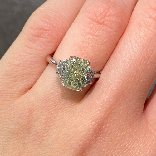 GIA-certified greenish yellow diamond ring with a radiant cut center stone and VVS2 clarity.